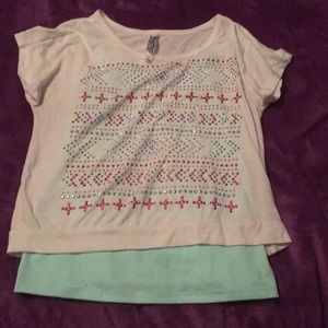 A teal undershirt with a cropped shirt to go over